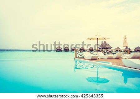 Outdoor swimming pool in Beautiful tropical Maldives island resort with beach and sea for nature holiday vacation background concept - Vintage Filter and Boost up color Processing