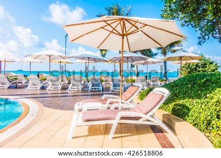 Beautiful luxury umbrella and chair around outdoor swimming pool in hotel resort - Holiday Vacation concept for background