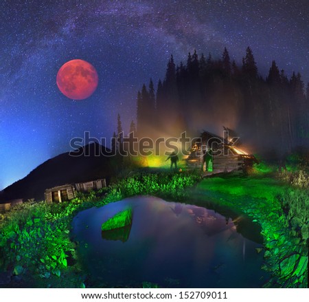 Milky Way passes over an arc of silver Transcarpathian field Barlebash - Berlibashka, moon lights up the mountain Latundur. In the house live shepherds herding horses, cows and sheep all summer.