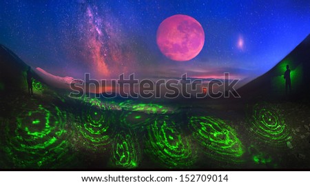 Full moon on the rise and the Milky Way, Night photography with the use of a green laser for the art of painting in the Carpathian mountains, Ukraine. Rise of the moon looks fantastic and incredibly