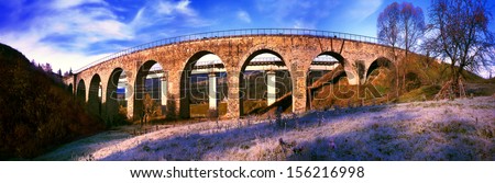 Ancient beautiful stone arch bridge, built by Austria before World War II, is still used by passenger and freight trains in modern Ukraine, but has been built next to the new concrete bridge