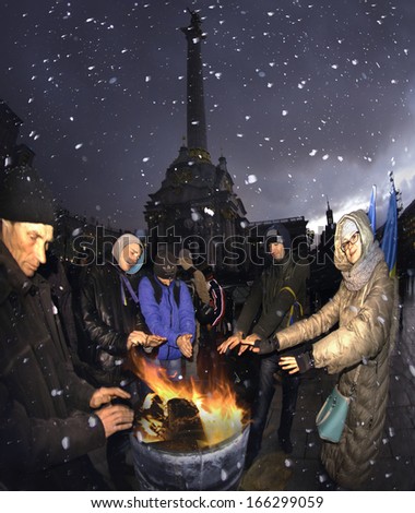 Kyiv, Kiev, Ukraine- December 2, 2013: Protesters citizens trying to warm around the fire barrels, on the background the Maidan, wind and snow can not disperse the people patriots home