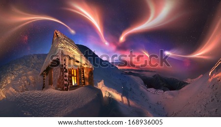 winter holidays in the mountains, on the background of blue mountains, red dawn, near the safe haven-alpine rescuers cabin atop Hoverla, Ukraine, and in the morning to climb to a height of Montenegro