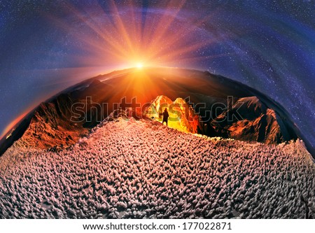 Moonrise over Mika-Mare, in the Carpathian Mountains. The slope of the frozen mountains lit by a powerful LED light warm light, to achieve a fantastic effect \