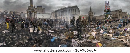 Kiev, Ukraine - February 20, 2014: Freed from government troops Evromaydan. The smoke protesters hiding from snipers, collecting stones and bottles at the devastated area to the forward position