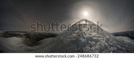 Snowy ridges Chornogory dressed in a blanket of snow and ice, alpine panorama at night with the moon look fantastic for the lone climber and terribly lonely ice Goverla mystical moon at sunrise