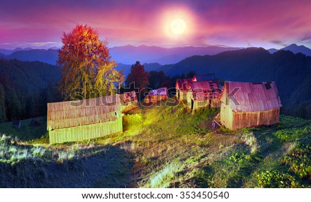 shepherds leave the pasture before the first snow and frost deserted house asylum sheds remain until next season, against the background of gold and red peaks of the Carpathians