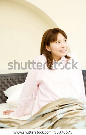 A pretty Japanese woman waking up in the morning