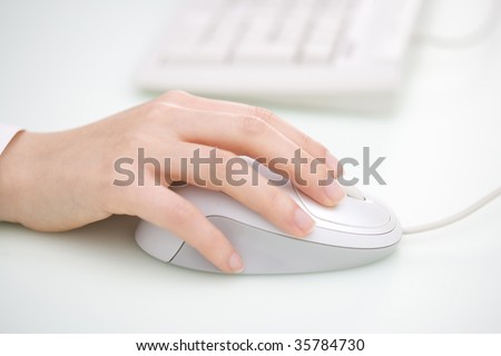 BUSINESS IMAGE-a woman\'s hand holding the white mouse