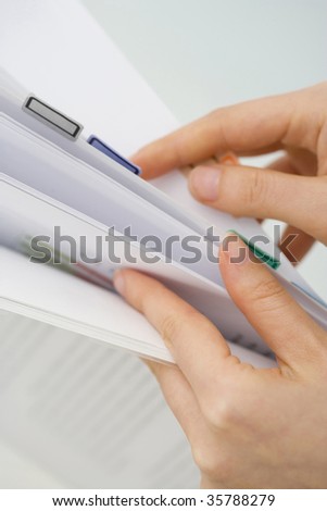 BUSINESS IMAGE-woman\'s hands turning over the sheet of file