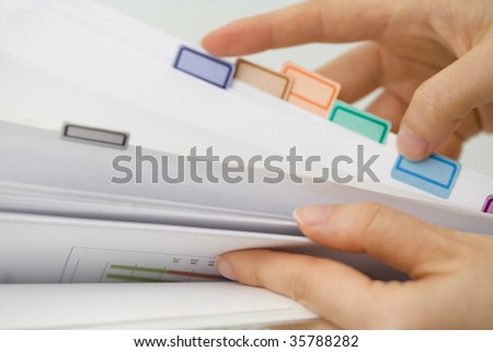 BUSINESS IMAGE-woman\'s hands turning over the sheet of file