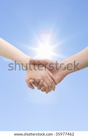 Close-up shot of hand in hand with the sunny weather
