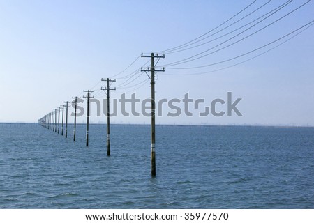 Utility poles with the beautiful sea