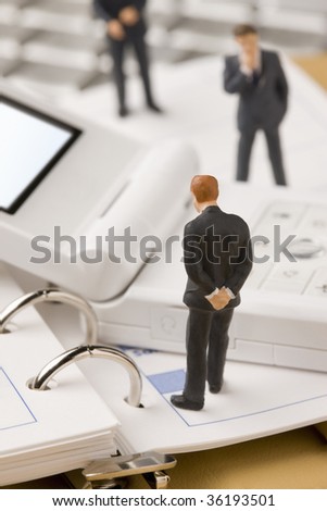 Three models of business man looking at white mobile