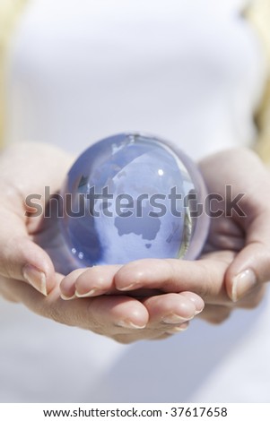 A globe on the female both hands.
