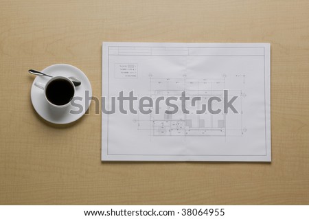 Drawing sheet and coffee on the floor.