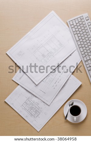 Drawing sheet,keyboard and coffee on the floor.