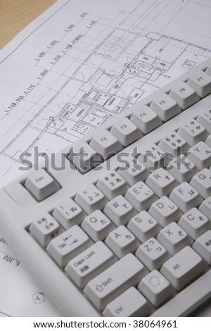 Close up shot of keyboard and drawing sheet.