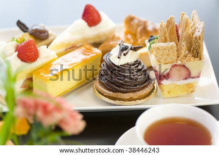 A plate of assorted cake with tea