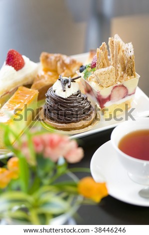 A plate of assorted cake with tea
