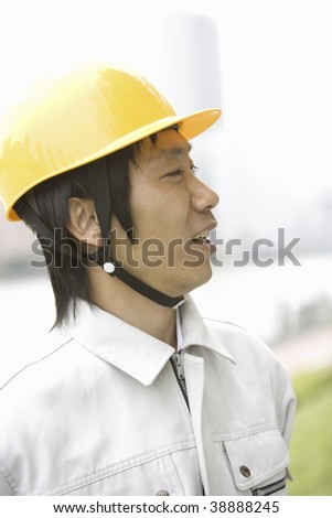 A workman with a hard hat is talking.