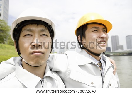 Workmen wearing hard hats standing together
