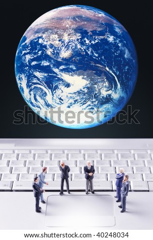 The businessmen who hold a meeting on the PC and globe background.