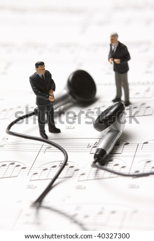 Businessmen on the sheet music and earphones.