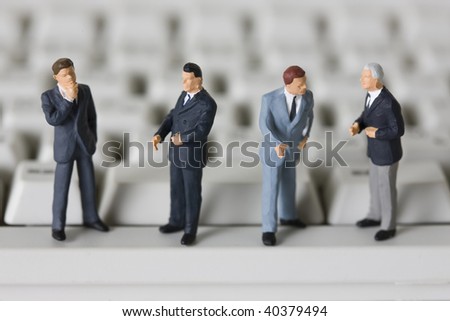 Figures of the businessman who lines up the side of a PC.