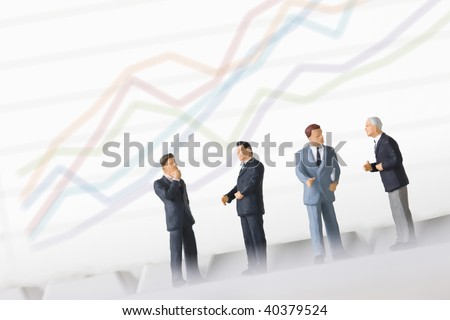 Figures of the businessman who lines up the side of a PC and chart background.