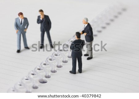 Figures of the businessman who lines up on the notebook.