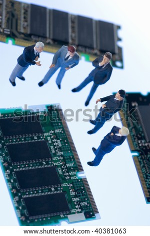 Figures of the businessman who communicates by the side of a computer chip.