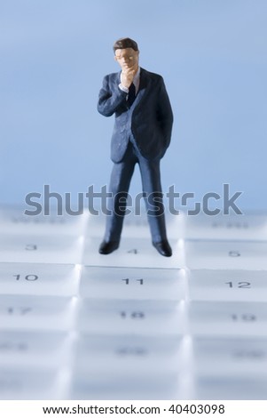 The businessman who stand on the schedule calendar.