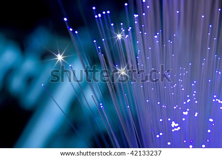 Hand holding optical fiber on blur background