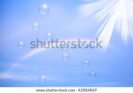 Rainbow and bubbles in the blue sky
