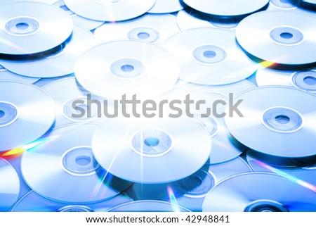 Many DVD and CD discs scattered as a background