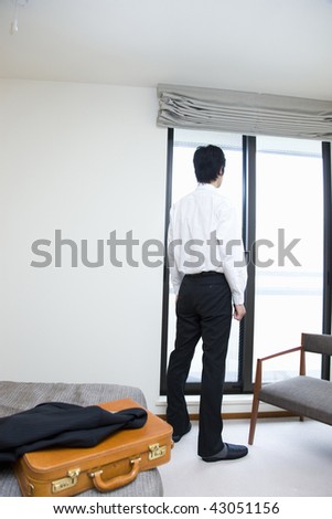 A young businessman standing by the window