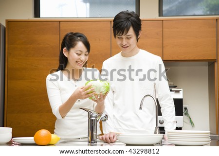 A young loving couple in their kitchen