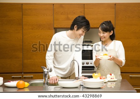 A young loving couple in their kitchen