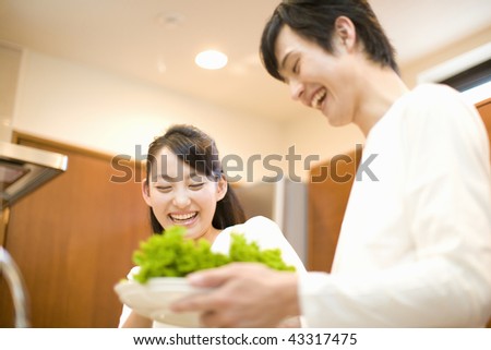 A young couple smiling in the kitchen