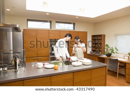 A young couple smiling in the kitchen