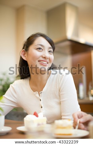 A smiling young woman with cake