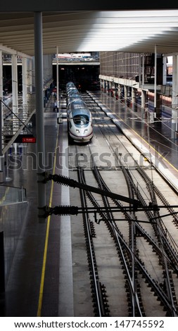 MADRID - JULY, 24: High speed trains in Atocha Station on July 24, 2012 in Madrid, Spain. Spain\'s main cities are connected by high-speed trains.