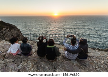 ALGARVE, PORTUGAL - AUGUST 05: Tourists enjoy the sunset at Cape Saint Vincent  on the Atlantic coast on August 05, 2013, Portugal. \