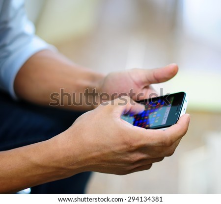 Close-up Of Young Man Playing Video Game On Mobile