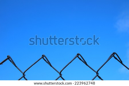 Chain link fence top and blue sky