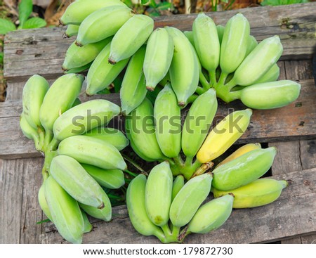 raw banana lay down on wooden plate
