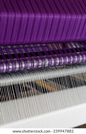 Part of loom with purple thread, beautiful color thread of loom,