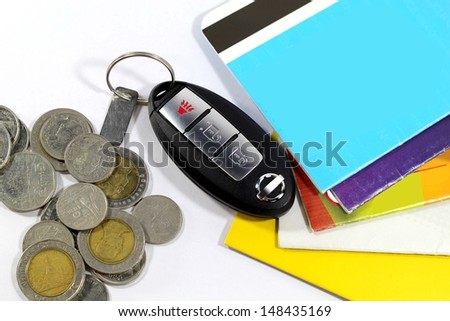 Keys in a pile of money and bank accounts. Business Concepts spending.