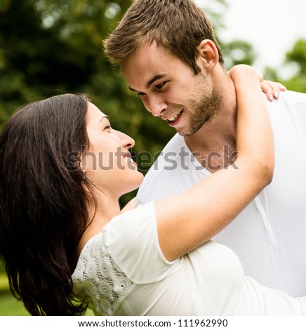 Young happy couple enjoying life - man carrying woman